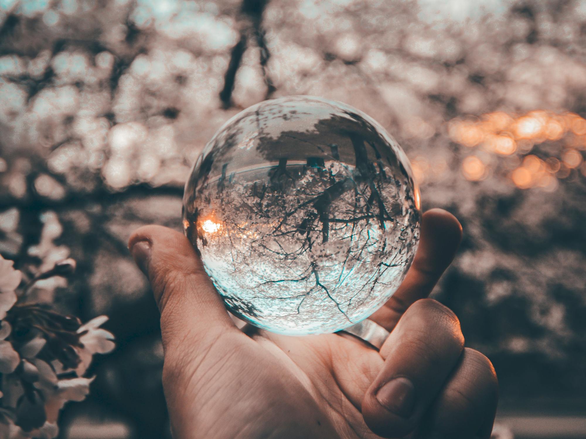 hand with glass ball perspective